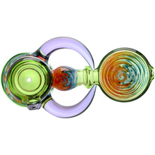 The Calibear Horned Wig Wag Hammer Pipe is a vibrant borosilicate glass hand pipe featuring swirling green, orange, blue, and purple patterns with circular shapes and intricate details, shown from above.