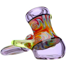 The Calibear Horned Wig Wag Hammer Pipe is a vibrant borosilicate glass piece with swirling red, yellow, green, and orange patterns, translucent purple and yellow sections, and a unique artistic horned design.