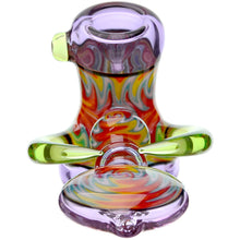 The Calibear Horned Wig Wag Hammer Pipe is a colorful borosilicate glass hand pipe with swirling red, yellow, and green patterns, translucent purple and green accents, curved handles, and a wide base for bold visual appeal.