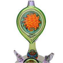 The Calibear Horned Wig Wag Upright Bubbler features a teardrop-shaped design with swirling orange, red, blue, and yellow colors at its center, set on a striking green and purple glass base.