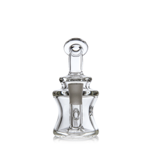 The MJ Arsenal Jammer Mini Dab Rig features clear borosilicate glass, a rounded base, narrow neck, and knob-like stopper. Its frosted section and smooth curves create an elegant yet modern appearance that is both sleek and functional.