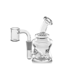 The MJ Arsenal Jammer Mini Dab Rig is a clear borosilicate glass rig with a curved neck, wide base, side quartz banger, and a small black logo on the chamber. Photographed against a white background.