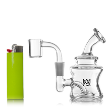 The MJ Arsenal Jammer Mini Dab Rig, made of clear borosilicate glass with a bent neck and side arm, sits next to a bright green lighter on a white background. The pipe displays an "M" logo topped with a crown.