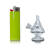 A lime green lighter stands upright next to the MJ Arsenal King Bubbler, a small, clear blunt bubbler shaped like a sailboat, both resting on a white background.