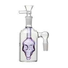 The 14mm Skull Ash Catcher (45° or 90°) features a clear glass bottle shape with a purple skull inside, two angled joints, and a flower bowl on top. Compatible with any 14mm water pipe. Shown against a white background.