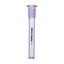 The Human Grade Color Downstem (14MM) stands upright on a white background, featuring a clear glass body with a purple cap and "HUMAN GRADE" in black text—precision-designed for optimal airflow and purity.