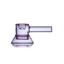 The MJ Arsenal Grotto Glass Pipe is a translucent purple hand pipe with a cylindrical stem and wide, flat base, made from durable borosilicate glass, shown against a white background.