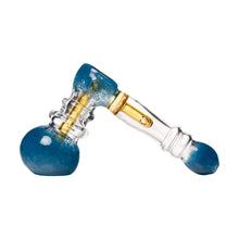 The Frit Hammer Bubbler features blue, clear, and yellow sections with a rounded base, angled neck, and bulbous mouthpiece, shown on a white background.