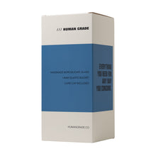 White and blue rectangular box labeled "Human Grade." Features handmade borosilicate glass, 14mm quartz bucket, mushroom cloud perc. Includes The Nuke Glass Rig, carb cap, and everything you need for your preferred consumption method.