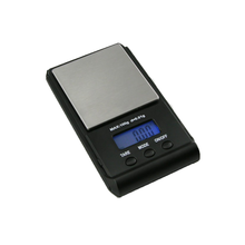 The WeighMax Scales is a digital scale with a 750g capacity, stainless steel surface, back-lit LCD display (shows 0.00), and three buttons: Tare, Mode, and On/Off.