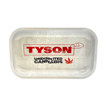 The Tyson 2.0 Rolling Tray is a rectangular metal tray with a white, slightly scratched surface. It displays red TYSON 2.0, black UNDISPUTED CANNABIS text, and a red leaf graphic, designed for legal use only.