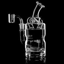 The MJ Arsenal Turbine Mini Dab Rig, made of clear borosilicate glass, shows off its swirling water action and sleek curves against a black background, highlighting the rig’s intricate design.