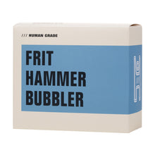 A beige and blue box labeled "Frit Hammer Bubbler" in bold black letters, with "Human Grade" printed above and a simple white line drawing of a hammer-shaped glass bubbler on the right side.