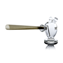 The MJ Arsenal The Martian® Original Blunt Bubbler™ is a clear, vase-shaped glass bubbler with a small logo that holds a blunt horizontally, providing smooth water filtration and resting on a reflective white surface.