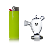 A green lighter stands upright beside the small, clear MJ Arsenal Martian Original Blunt Bubbler—a glass smoking accessory with water filtration and side spout—both displayed on a white background.