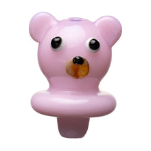 The Human Grade Bear Carb Cap is a small, glossy pink accessory shaped like a bear’s head with round ears, large black and white eyes, and a brown nose, shown isolated on a white background.