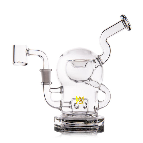 The MJ Arsenal The Plasma Core Rig is a clear borosilicate glass water pipe with a spherical chamber, angled mouthpiece, side arm for a bowl attachment, and features MJ Arsenal’s small yellow M logo near the base.