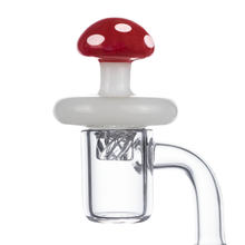 The MJ Arsenal Mushroom Spinner Carb Cap features a clear chamber and a red and white spotted mushroom design—an eye-catching glass pipe attachment perfect for fans of unique, fungus-inspired dabbing accessories.