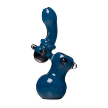 The Human Grade Sherlock Bubbler is a handmade blue borosilicate glass sculpture with a curved, elongated neck, rounded base, and protruding accents, resembling an abstract pipe, displayed on a white background.