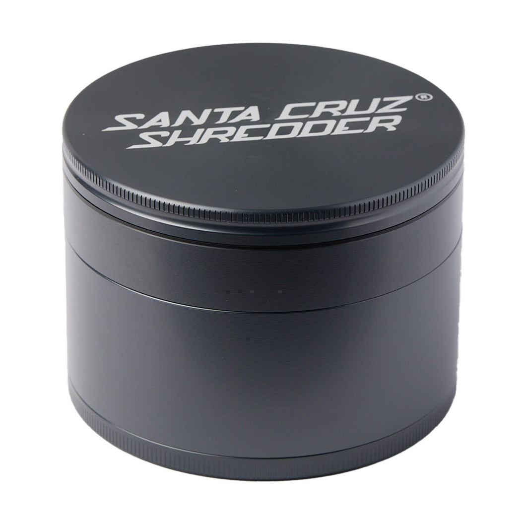 A black, cylindrical Santa Cruz Shredder Large 4-Piece Grinder made of anodized aluminum with white text on the lid is displayed against a white background.