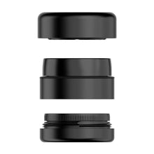Three black camera lens adapters or extension tubes are stacked vertically against a white background, their textured details reminiscent of the Flower Mill 2" Next Gen Premium Grinder.