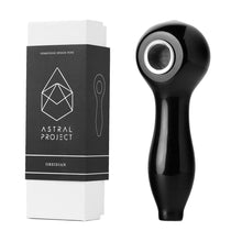 The Gemstone Spoon Pipe, made from black obsidian with a gemstone bowl, is displayed beside its white and black Astral Project packaging, which features a geometric crystal design.