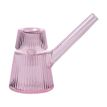 The NWTN Home Deco Bubbler is a pink borosilicate glass pot with a long handle, vertical ribbed texture, and a matching ribbed lid. Its modern, elegant Art Deco-inspired design features a transparent, subtly tinted appearance.