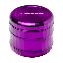 A metallic purple, cylindrical aluminum Human Grade Grinder 6M (2.5") with a textured grip and "HUMAN GRADE" in white on the lid, displayed against a white background.