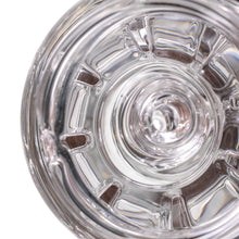 Close-up, top-down view of the inside of the MJ Arsenal Alpine Series - Halo Peak Top, a clear, empty borosilicate glass piece featuring symmetrical patterns and surface reflections.