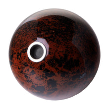 The Astral Project Globe Pipe is a round, glossy brown and black speckled piece with a metallic circular opening on one side, displayed against a white background.