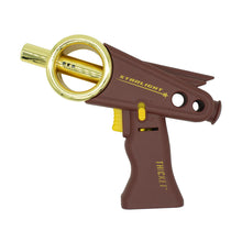 The Thicket Starlight Torch is a novelty torch lighter styled as a retro sci-fi ray gun, featuring a brown and gold color scheme, gold ring-shaped barrel, yellow trigger, and labeled STARLIGHT and THICKET for futuristic flair.