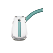The MJ Arsenal Bulb Bubbler is a clear borosilicate glass pipe featuring a curved teal stem and internal teal downstem, designed for portability and shown on a white background.