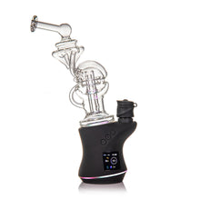 The MJ Arsenal Fabcycler Focus V Carta Top is a modern electronic dab rig with a clear borosilicate glass bubbler and a black digital base with control buttons and display, inspired by the innovative Focus V Carta design.