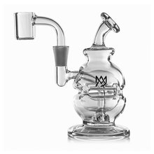 The MJ Arsenal Royale Mini Dab Rig is made of clear borosilicate glass with a rounded, sculpted body, bent neck, left-side banger, overlapping M logo, flat circular base, and a fab egg percolator for smooth hits.