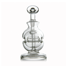 The MJ Arsenal Royale Mini Dab Rig is a clear borosilicate glass decanter with a rounded base, intricate fab egg-style inner percolator, and matching stopper, shown against a white background.