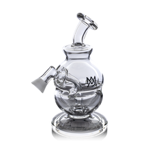 The MJ Arsenal Royale Vape Edition is a clear glass water pipe with a bulbous chamber, angled mouthpiece, side arm joint, and black front logo. This dab rig stands on a round base and is shown against a white background.