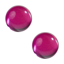 Two polished MJ Arsenal Ruby Terp Pearls (6mm) with a deep reddish-pink color reflect light from their smooth surfaces on a white background—perfect as unique banger accessories.