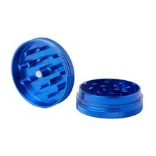 The 2 Piece Flat Grinder is a blue metal herb grinder with two detached parts showing sharp grinding teeth inside, placed upright on a white background. It comes in various colors and sizes.
