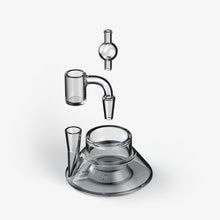 A digital rendering of the SOFTGLASS TANDEM BASE KIT’s four transparent glass components, including a Quartz Bucket and Glass Base, float vertically aligned above a white background, suggesting assembly into a functional device.