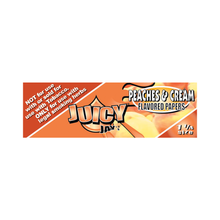 Juicy Jay's Flavored Papers, Peaches & Cream, 1 1/4 size, orange pack with triple-dipped flavoring. Left side states: not for tobacco use—only for legal smoking herbs.