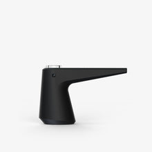 The SOFTGLASS PIER BUBBLER, featuring a sleek black finish, cylindrical base, and angled spout, stands against a white background—its contemporary design echoes the smooth lines of borosilicate glass.