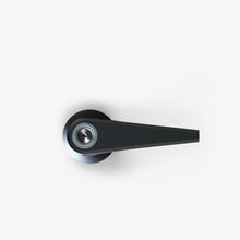 Minimalist top-down view of a modern, black door handle with a cylindrical base and straight lever on a plain white background—its sleek form echoing the SOFTGLASS PIER BUBBLER design.