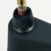 Close-up of the SOFTGLASS PIER BUBBLER, a sleek black device with a borosilicate glass chamber and a cartridge inserted on top; features a subtle logo on its rubberized section.