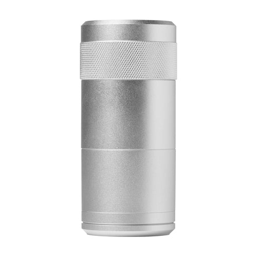 The MJ Arsenal Capsule Grinder Dugout, a silver cylindrical metal device with a textured grip near the top, resembling a portable herb grinder, stands upright against a white background.