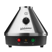 The Storz & Bickel Volcano Classic is a silver, cone-shaped vaporizer with a temperature dial, HEAT (red) and AIR (green) indicators, convection heating, and the Volcano logo on the front—an iconic German device.