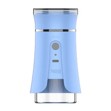 The Yocan iShred Electric Grinder is a sleek blue cylindrical device with a power button, indicator light, metallic top band, Type-C charging, and a transparent bottom compartment.