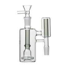 The Human Grade The Inverter Ash Catcher is a clear glass bong attachment with a cylindrical chamber, vertical mouthpiece, side percolator, 14mm joint connectors, and an ash catcher feature for water filtration and smoking.