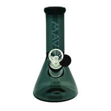 The MAV 7" Two-Tone Mini Beaker is a dark green borosilicate glass water pipe with "MAV" vertically on the neck, an ice pincher, a clear 14mm male bowl, and a black circular accent.