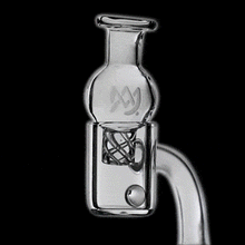 A close-up animated image of the MJ Arsenal Spinner Carb Cap with terp pearls and circular airflow, showcasing a spinning pearl and airflow inserts for vaporizing concentrates, set against a black background.