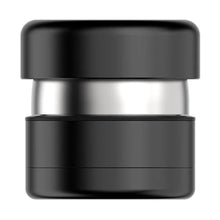 A black and silver cylindrical coffee tamper with flat ends, ideal for pressing espresso grounds, pairs well with the Flower Mill 2" Next Gen Premium Grinder for precise extraction.